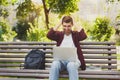 Desparate young man using a laptop outdoors