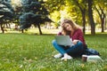 Desparate young woman using a laptop outdoors