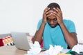 Desperate african american man at desktop at home