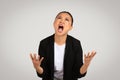 Desperate Asian businesswoman with an anguished expression, hands up in the air Royalty Free Stock Photo