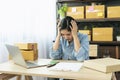 Desperate Asian woman stress headache depressed from startup small business at home office. Failure business woman work at home