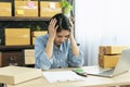 Desperate Asian woman stress headache depressed from startup small business at home office. Failure business woman work at home