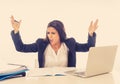 Desperate beautiful young businesswoman working on her laptop going crazy with loads of work Royalty Free Stock Photo