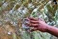 Desperate boy`s hand grazes the stormy water Royalty Free Stock Photo