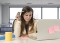 Desperate businesswoman suffering stress at laptop computer desk looking worried