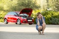 Desperate confused woman stranded with broken car engine crash accident calling on mobile phone Royalty Free Stock Photo