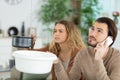 desperate couple callling to insurance worried about home leaks Royalty Free Stock Photo