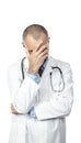 Desperate doctor holds his head up with one hand. Concept of stress and failure at work