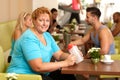 Desperate fat woman in gym holding water bottle