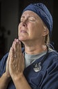 Desperate Female Doctor or Nurse Pleading in Prayer Royalty Free Stock Photo