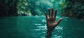 Desperate hand reaching out from tranquil water in lush green environment Royalty Free Stock Photo