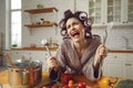 Unhappy young housewife sick and tired of cooking and housework crying in the kitchen Royalty Free Stock Photo