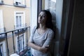 Desperate Latin woman at home balcony looking destroyed and depressed suffering depression