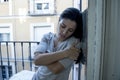 Desperate Latin woman at home balcony looking destroyed and depressed suffering depression