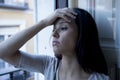 Desperate Latin woman at home balcony looking destroyed and depressed suffering depression