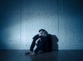 Desperate lonely unhappy caucasian man suffering from depression sitting alone on floor at home Royalty Free Stock Photo