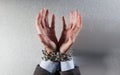 Desperate man hands tied with chain begging for employee victim Royalty Free Stock Photo