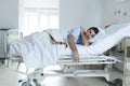 Desperate man at hospital bed alone sad and devastated suffering depression _ Royalty Free Stock Photo