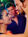 Desperate man looking at flirting couple in disco Royalty Free Stock Photo