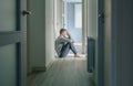 Man with mental disorder and suicidal thoughts sitting on the floor Royalty Free Stock Photo