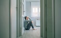 Man with mental disorder and suicidal thoughts sitting on room floor Royalty Free Stock Photo