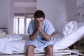 Desperate man sitting at hospital bed alone sad and devastated s Royalty Free Stock Photo