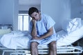 Desperate man sitting at hospital bed alone sad and devastated s Royalty Free Stock Photo