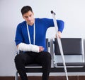 Desperate man waiting for his appointment in hospital with broke Royalty Free Stock Photo