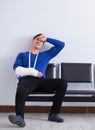 Desperate man waiting for his appointment in hospital with broke Royalty Free Stock Photo