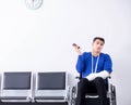 Desperate man waiting for his appointment in hospital with broke Royalty Free Stock Photo