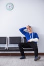 Desperate man waiting for his appointment in hospital with broke Royalty Free Stock Photo