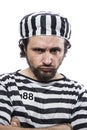 Desperate, portrait of a man prisoner in prison garb, over white Royalty Free Stock Photo