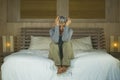 Dramatic lifestyle home portrait of attractive sad and depressed middle aged woman with grey hair on bed feeling upset suffering Royalty Free Stock Photo