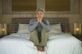 Dramatic lifestyle home portrait of attractive sad and depressed middle aged woman with grey hair on bed feeling upset suffering Royalty Free Stock Photo