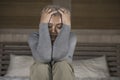 Dramatic lifestyle home portrait of attractive sad and depressed middle aged woman with grey hair on bed feeling upset suffering Royalty Free Stock Photo