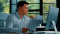Desperate sad asian japanese senior specialist businessman sit at office read documents scam notification error in