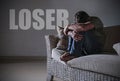 Desperate sad and frustrated man grieving at home sofa couch suffering depression problem and anxiety crisis crying with the word Royalty Free Stock Photo