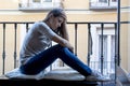 Desperate sad Latin woman at home balcony looking devastated and depressed suffering depression Royalty Free Stock Photo