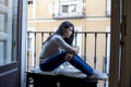 Desperate sad Latin woman at home balcony looking devastated and depressed suffering depression Royalty Free Stock Photo
