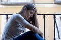 Desperate sad Latin woman at home balcony looking devastated and depressed suffering depression