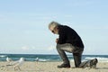 Desperate sad lonely man praying alone on ocean beach