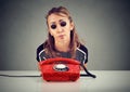 Desperate sad woman waiting for someone to call her