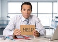 Desperate senior businessman in crisis working on computer laptop at office desk in stress under pressure