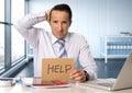 Desperate senior businessman in crisis working on computer laptop at office desk in stress under pressure Royalty Free Stock Photo