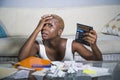 Desperate and stressed black afro American woman with calculator and paperwork banking in stress accounting business finance tax a Royalty Free Stock Photo