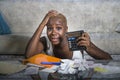 Desperate and stressed black afro American woman with calculator and paperwork banking in stress accounting business finance tax a Royalty Free Stock Photo