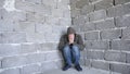 Desperate unhappy man by the wall. the concept of stress and hopeless