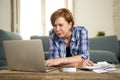 Desperate woman banking and accounting home monthly and credit card expenses with computer laptop doing paperwork Royalty Free Stock Photo