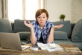 Desperate woman banking and accounting home monthly and credit card expenses with computer laptop doing paperwork Royalty Free Stock Photo
