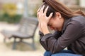 Desperate woman complaining alone in a park Royalty Free Stock Photo